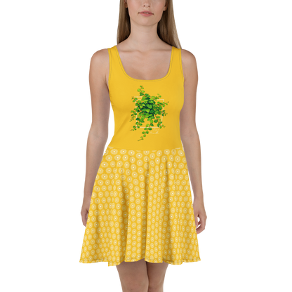 Robe d'été jaune évasée style "skater dress" avec imprimé botanique vert et bas à motifs géométriques blancs.